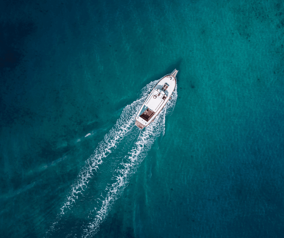 Aerial shot of boat moving through the water